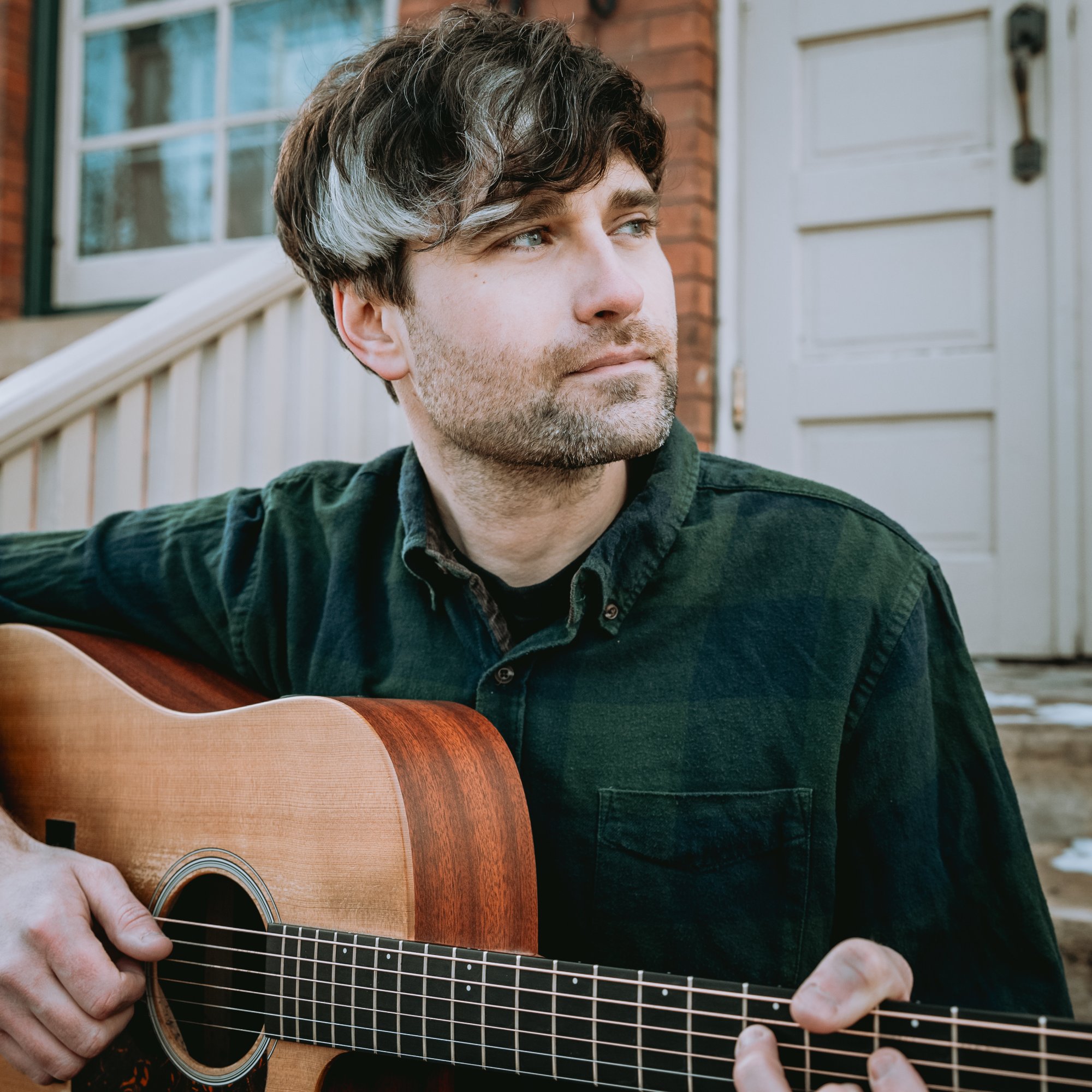 Dan Clayton with acoustic guitar